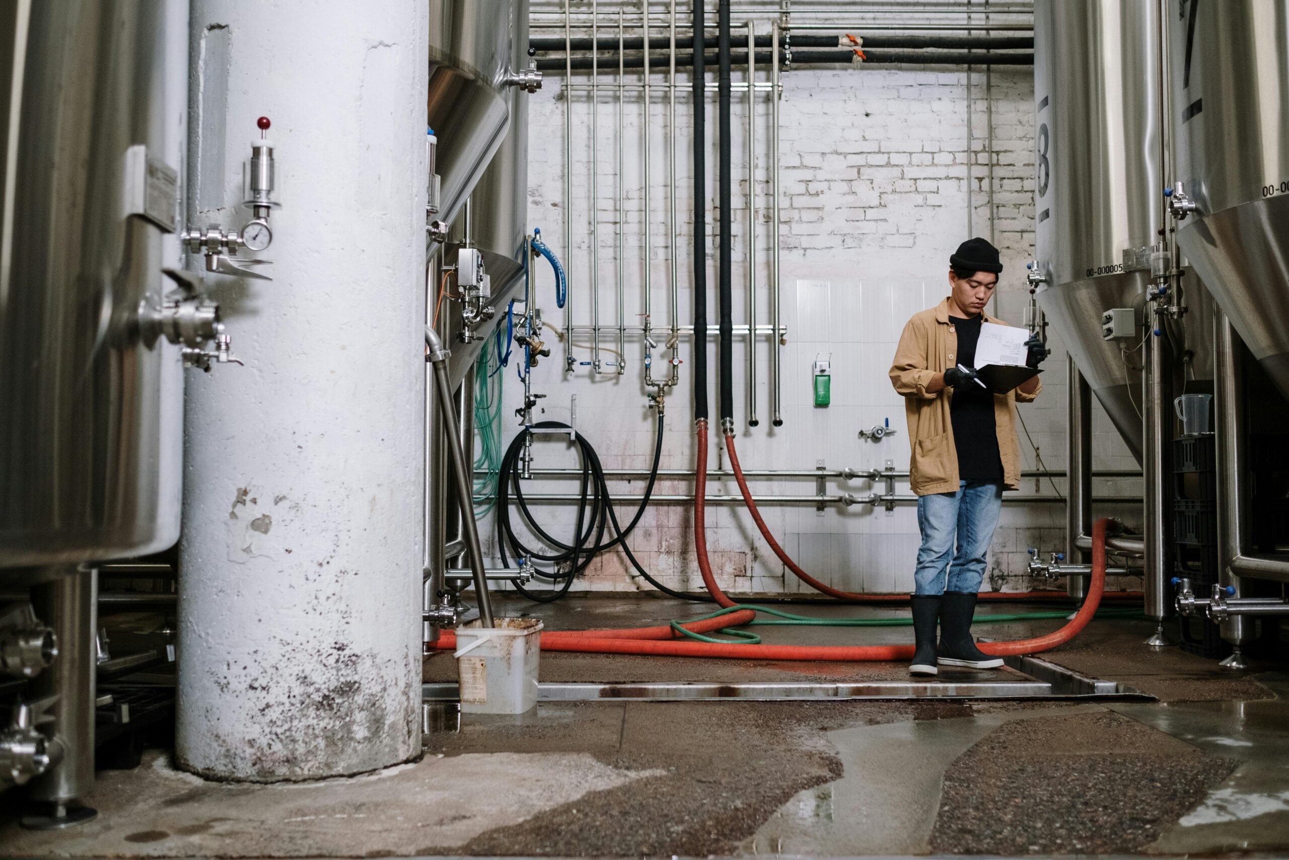 A man using quality control automation inspects products on a manufacturing production line